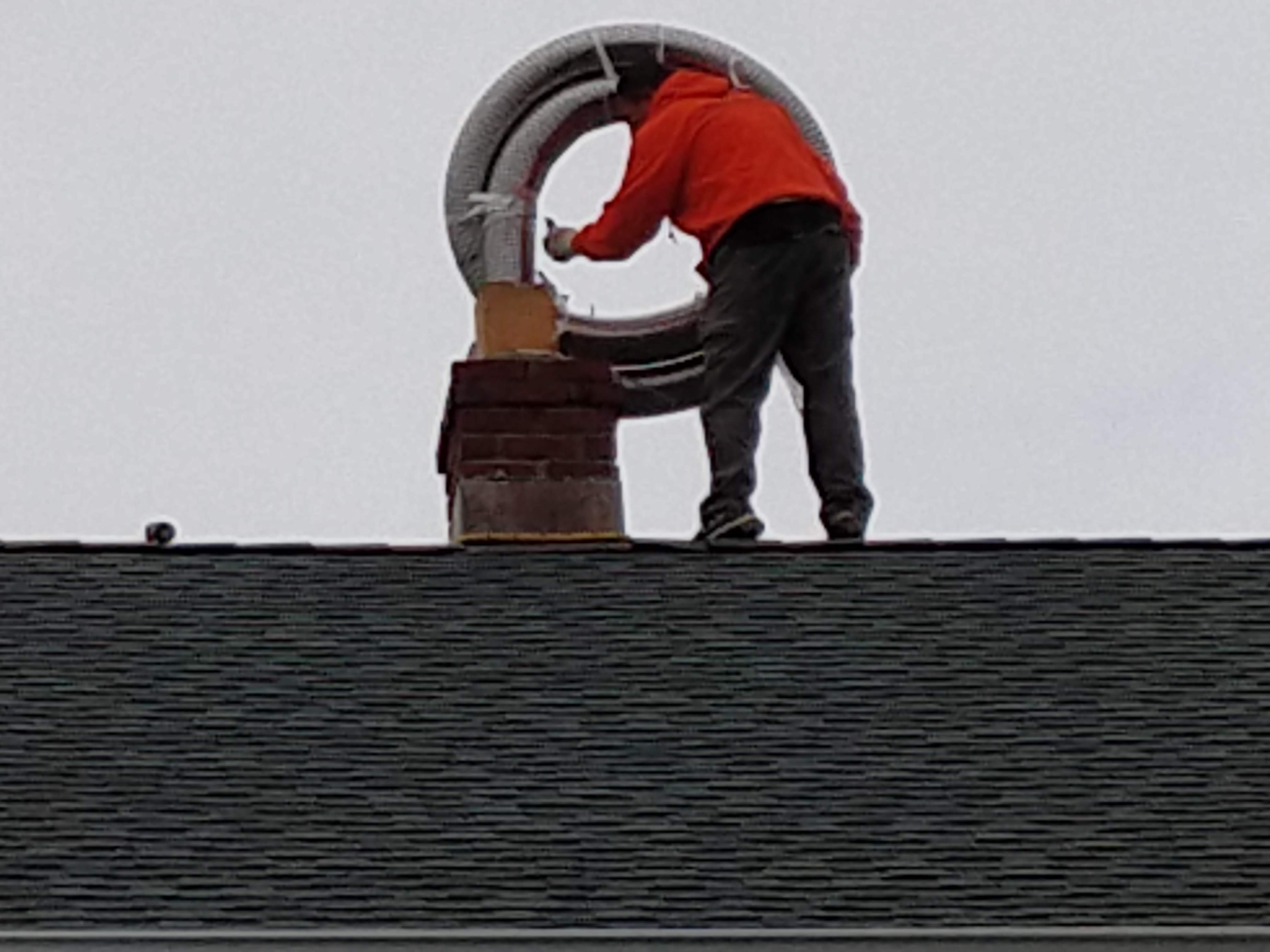 Flexible stainless chimney liner being installed in Oyster Bay, New York